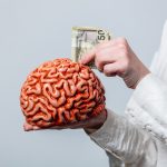 Portrait of beautiful blonde in white shirt with human brain on white background