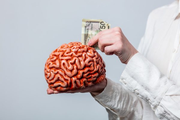 Portrait of beautiful blonde in white shirt with human brain on white background